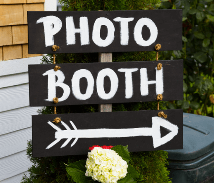Custom outdoor sign leading to the open air photo booth for an event