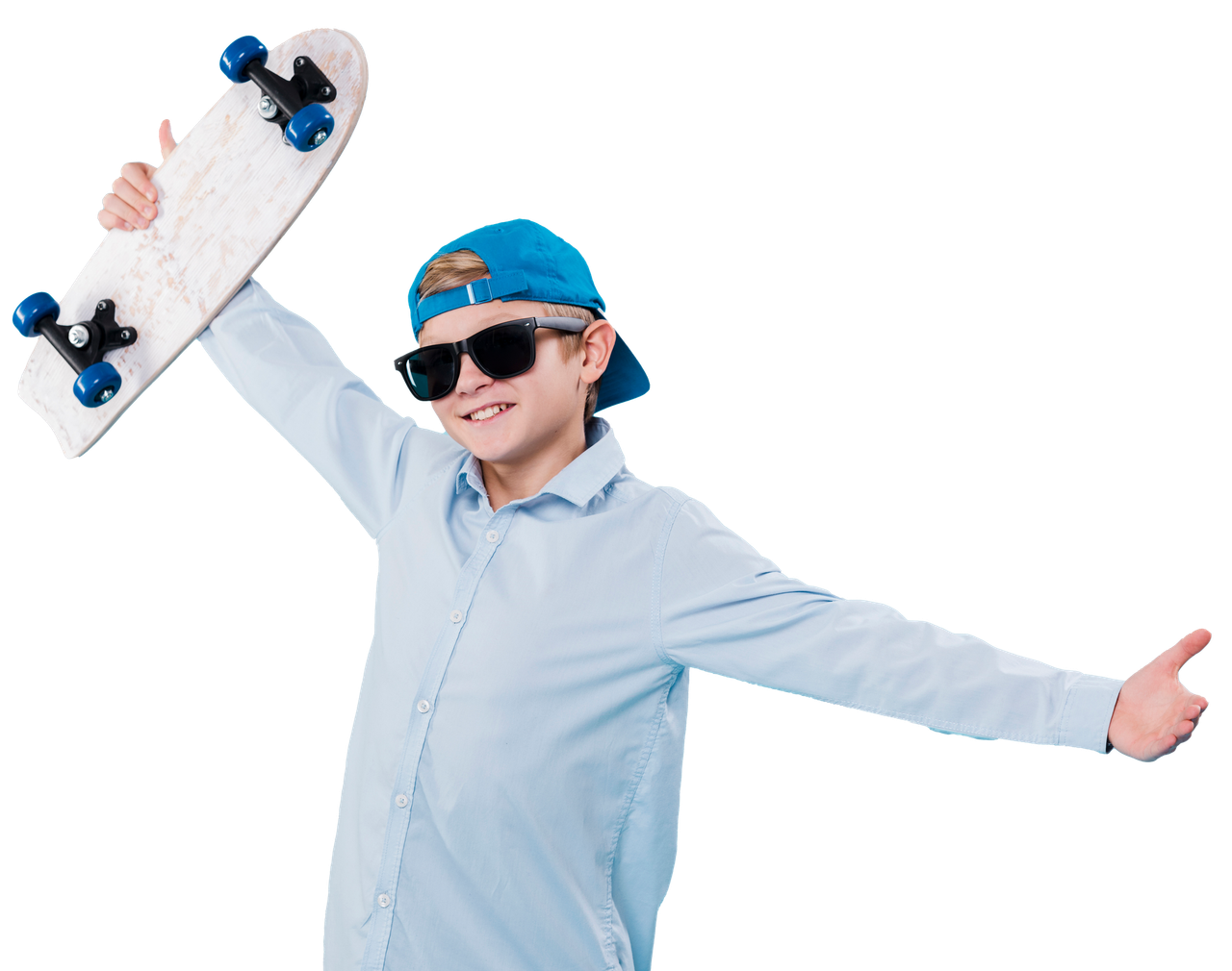 A young boy is holding a skateboard in his hand and giving a thumbs up.