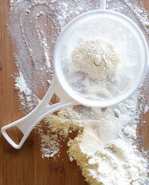 Flour In A Sifter — Supplements & Organic Produce in Mid North Coast, NSW