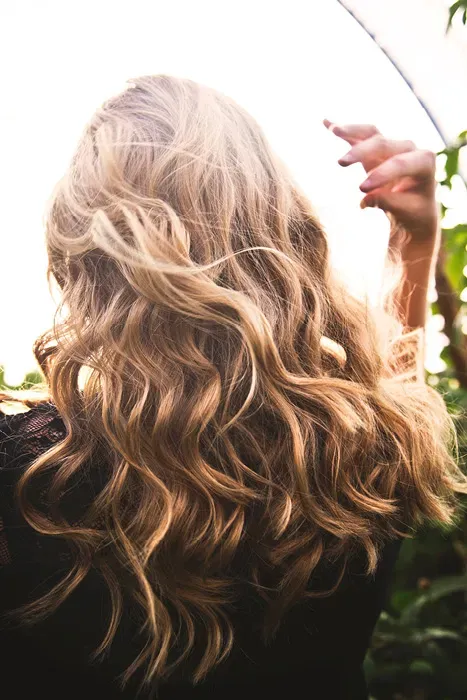 Woman With Long Brown Wavy Hair — Supplements & Organic Produce in Mid North Coast, NSW