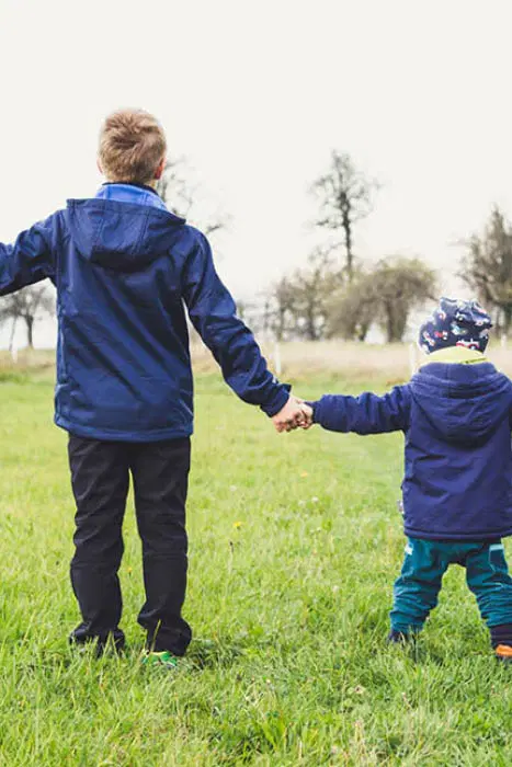 Two Kids Holding Hands — Supplements & Organic Produce in Mid North Coast, NSW