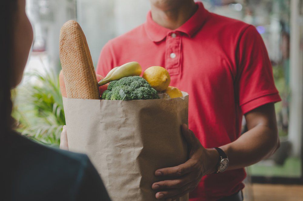 Handing Fresh Food on Paper Bags — Health Food Store in Taree, NSW