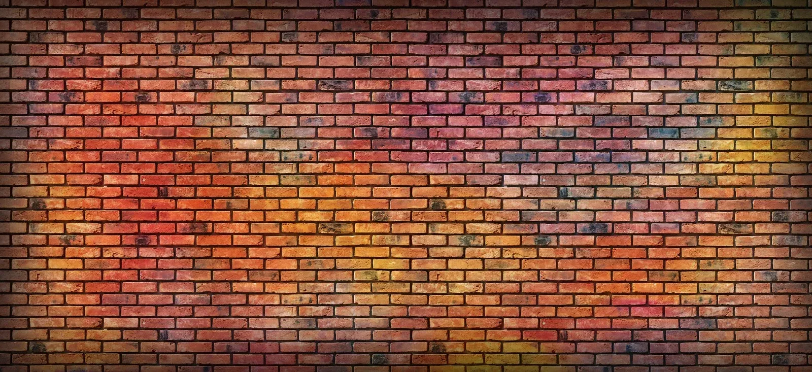 Brick wall with colorful graffiti-like splashes, shades of red, orange, and purple.