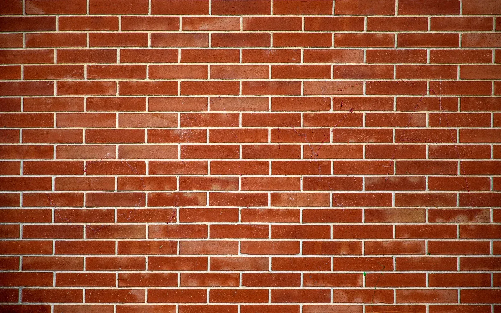 Red brick wall with white mortar.