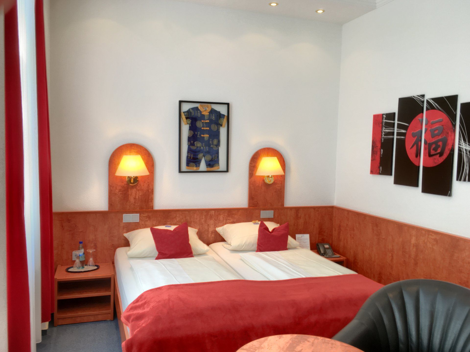 A hotel room with two beds and a chair