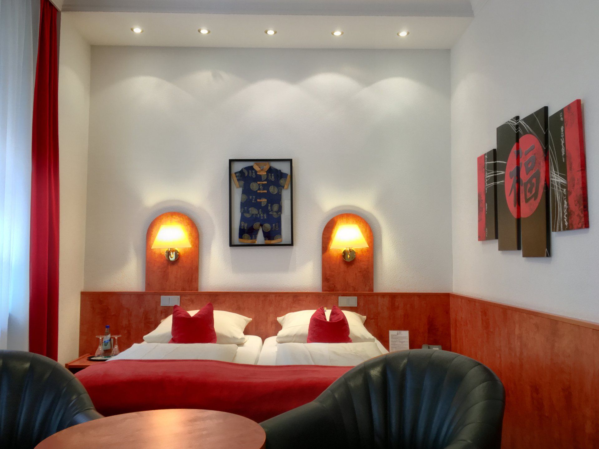 A hotel room with two beds and a table