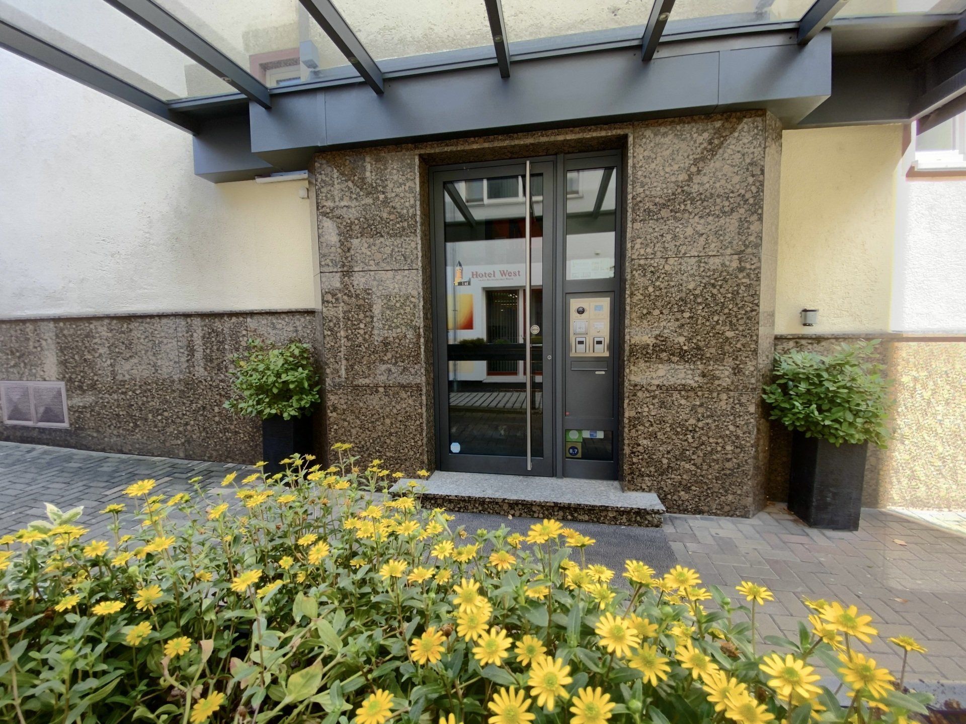 A building with yellow flowers in front of it