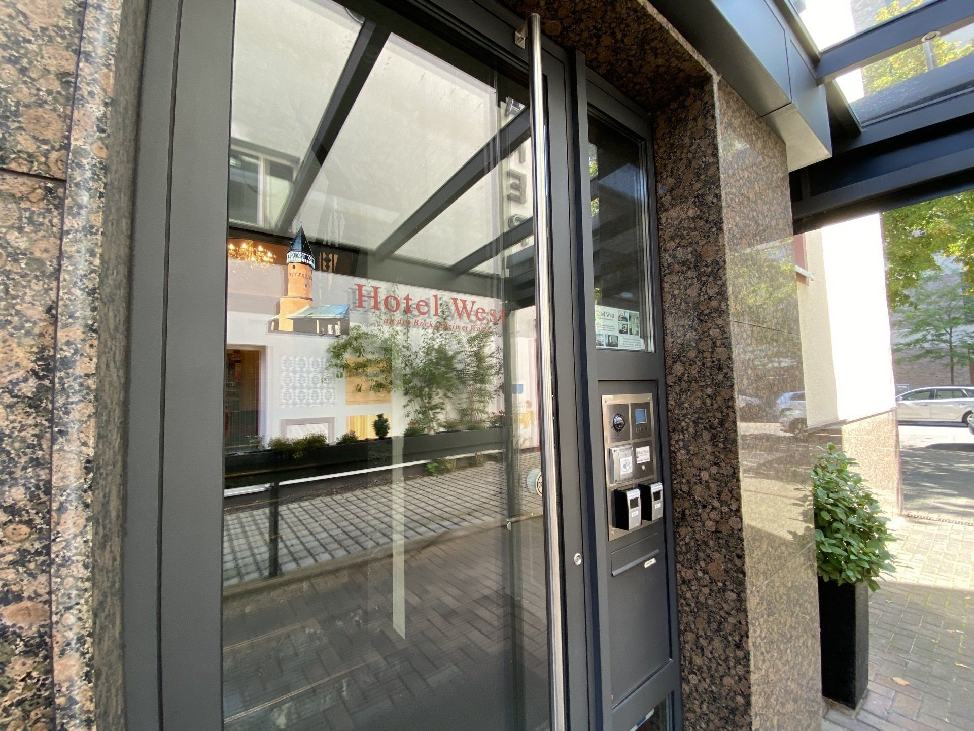 A building with a glass door and a reflection of a building in the glass door.