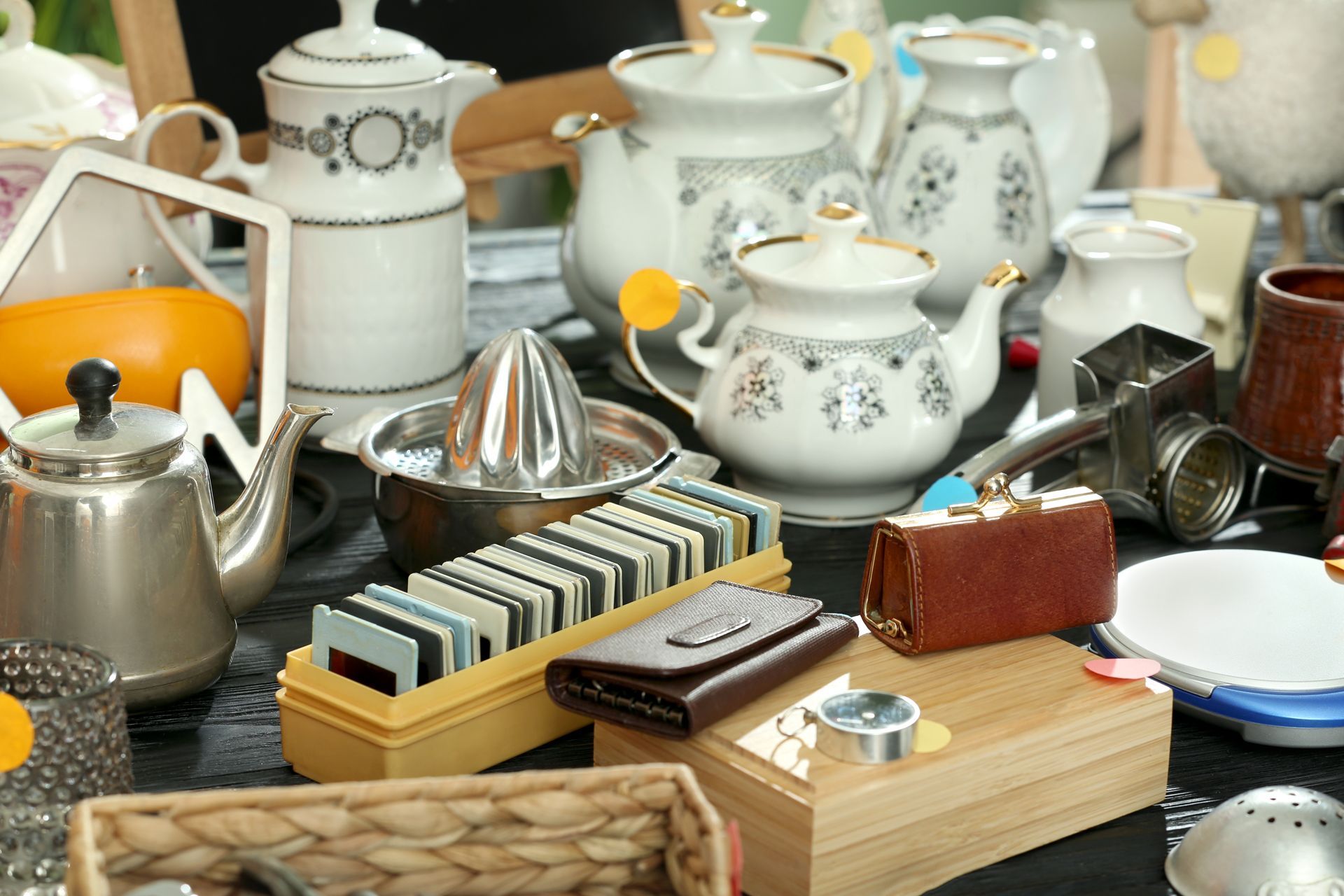 A Table Topped With a Variety of Teapots, Vases, and Other Items