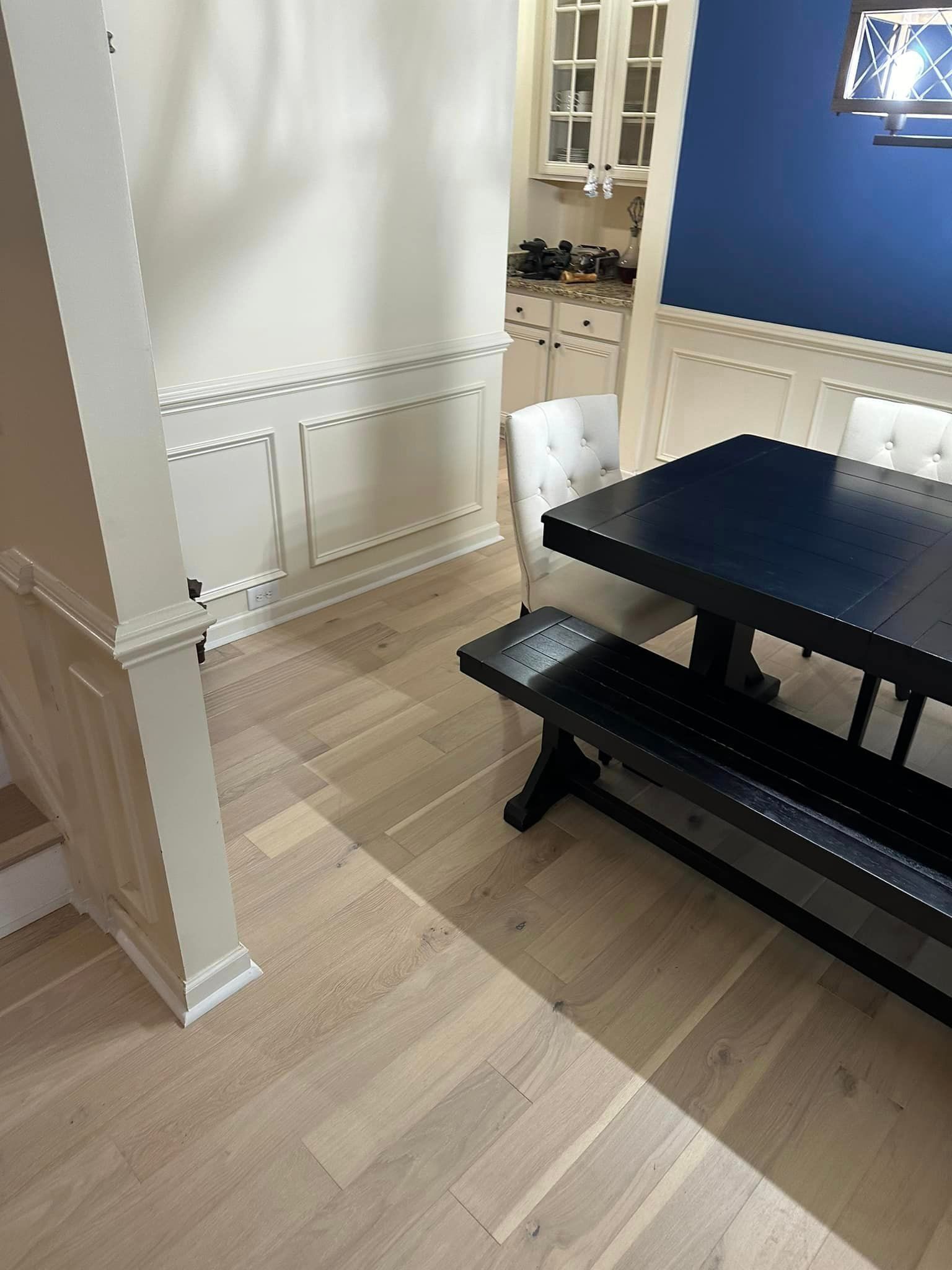hardwood floor with black table and white chair