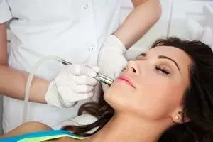 Cosmetic procedure using a handheld facial device on a reclining patient
