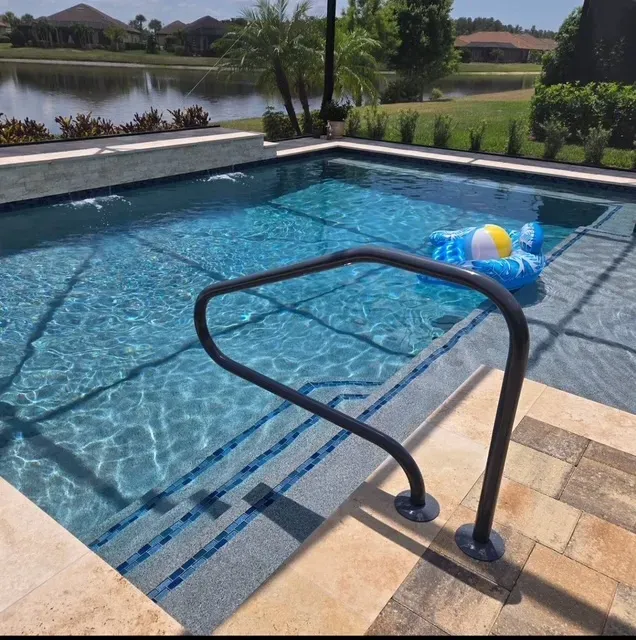A small swimming pool with a handrail and an inflatable in a sunny outdoor setting.