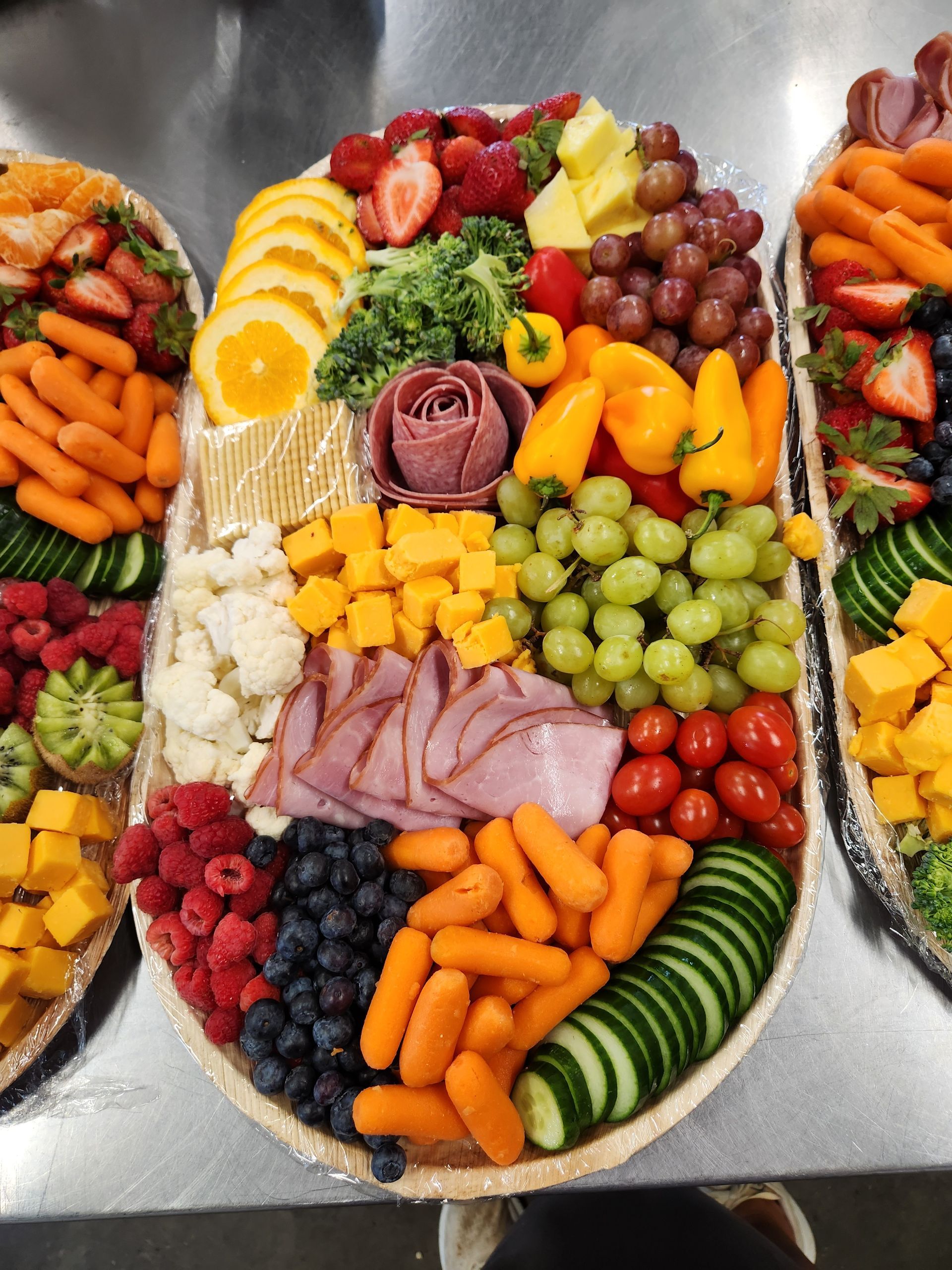 A tray of fruits and vegetables on a table.
