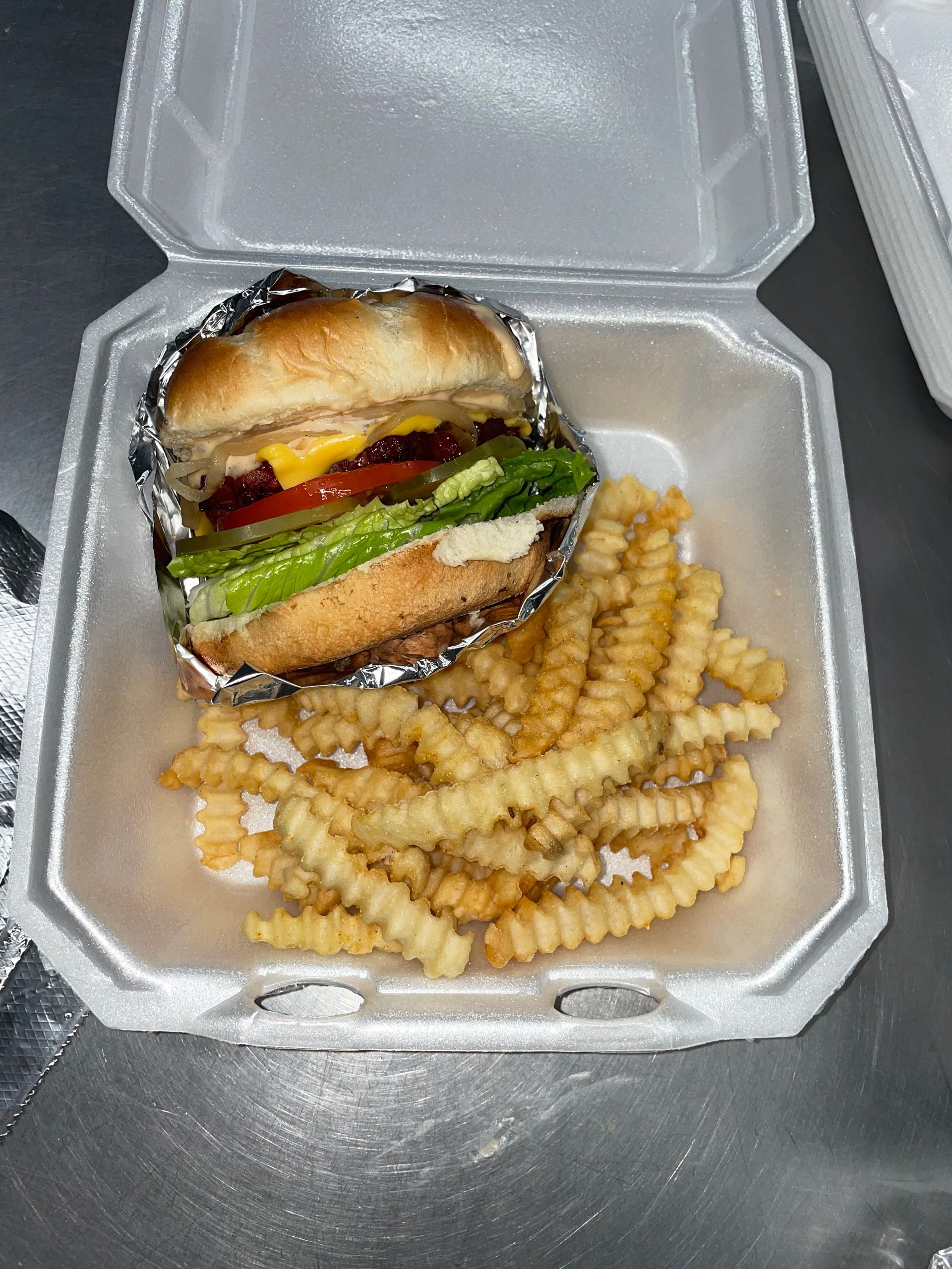 A bunch of ribs are sitting on top of each other on a pan.