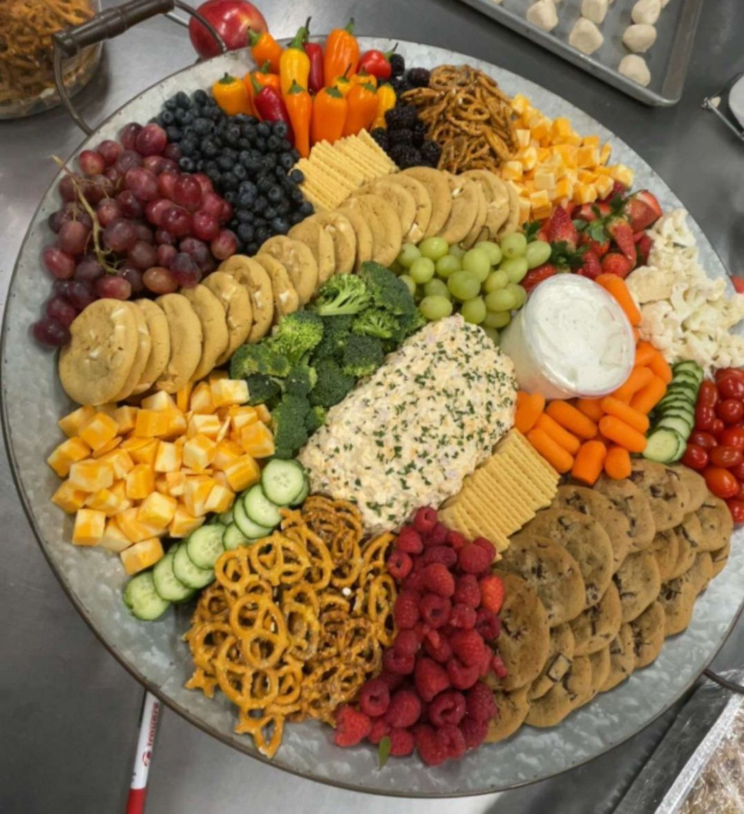 A large tray of food including fruits and vegetables