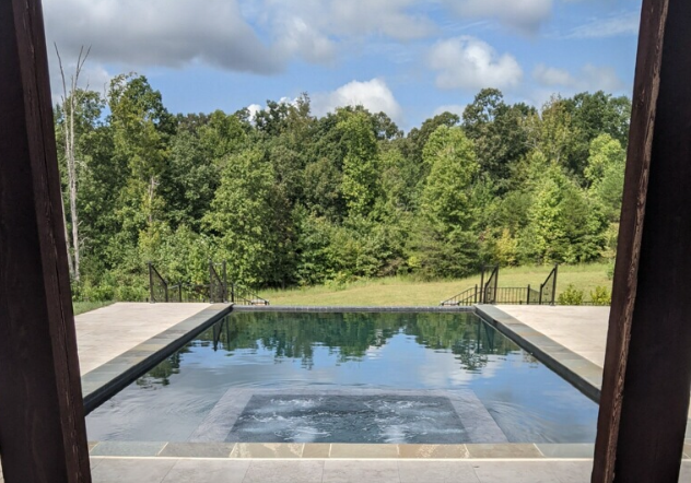 View of the pool through a window glass — Greenville, SC — AAA Custom Pools