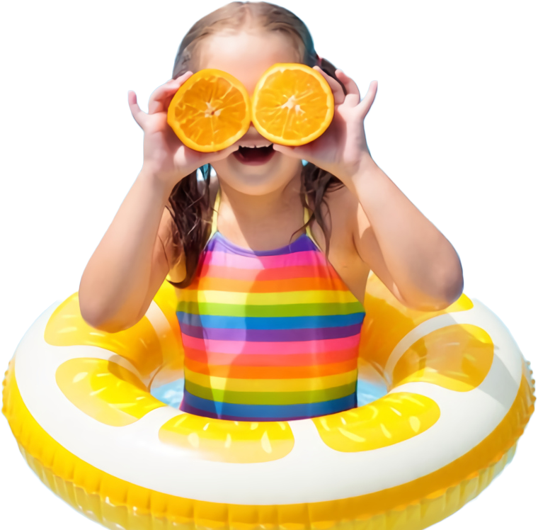 A little girl in a colorful bathing suit is holding slices of orange in front of her eyes