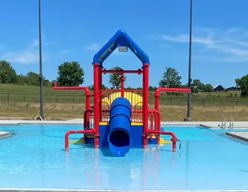 A colorful water slide is in the middle of a swimming pool