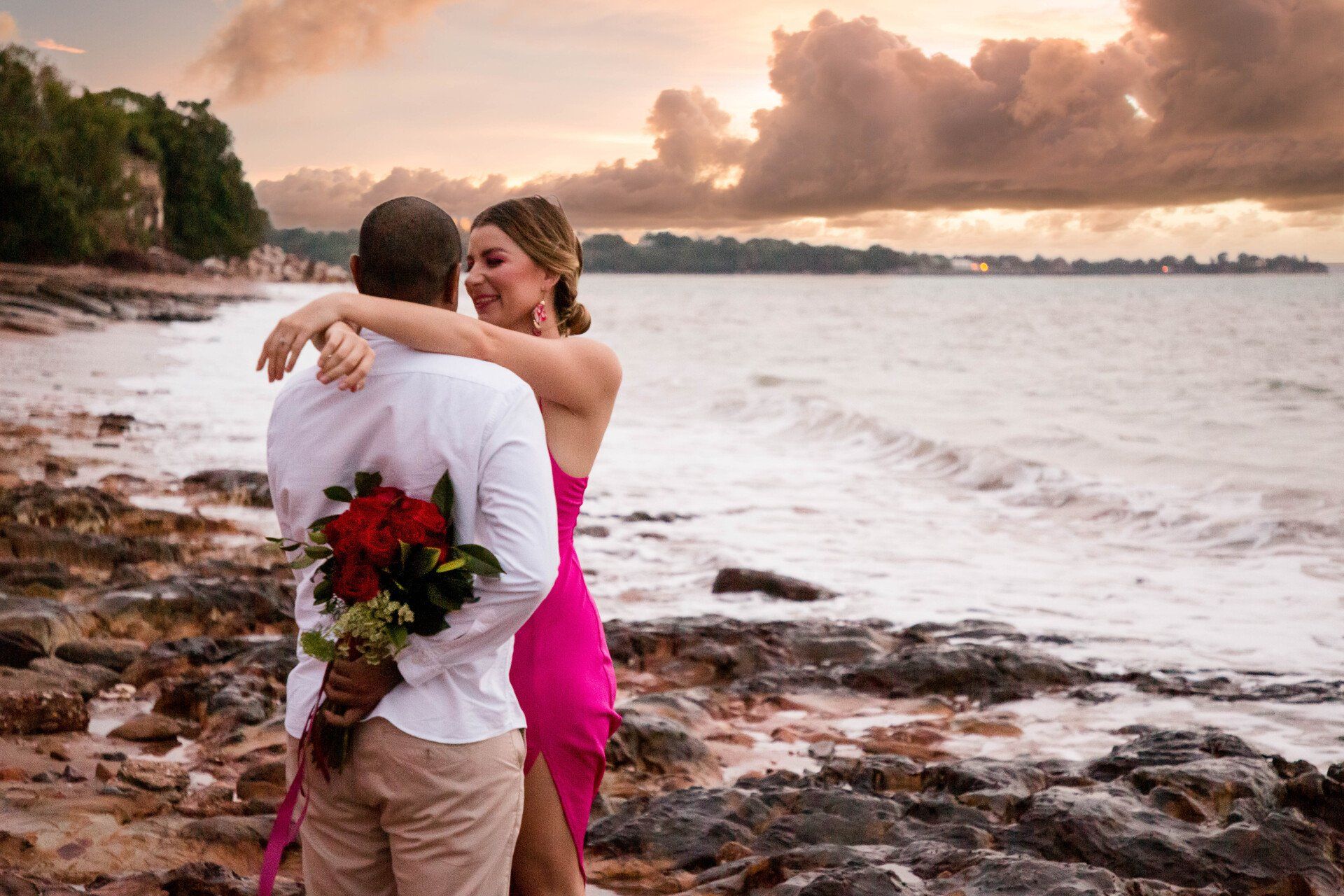 Beautiful beach engagement scene in Darwin, accented with delicate flowers, capturing the moment's bliss.