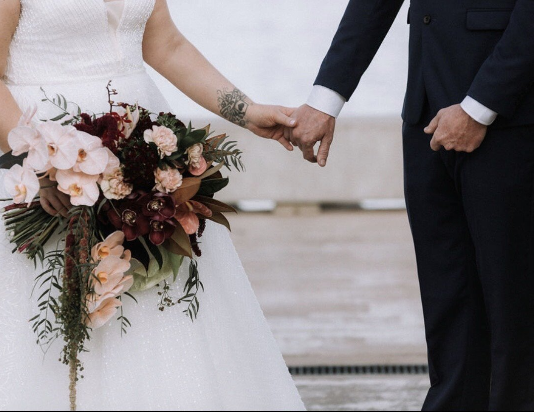 Intimate moment between bride and groom in Darwin, enhanced with delicate flowers.
