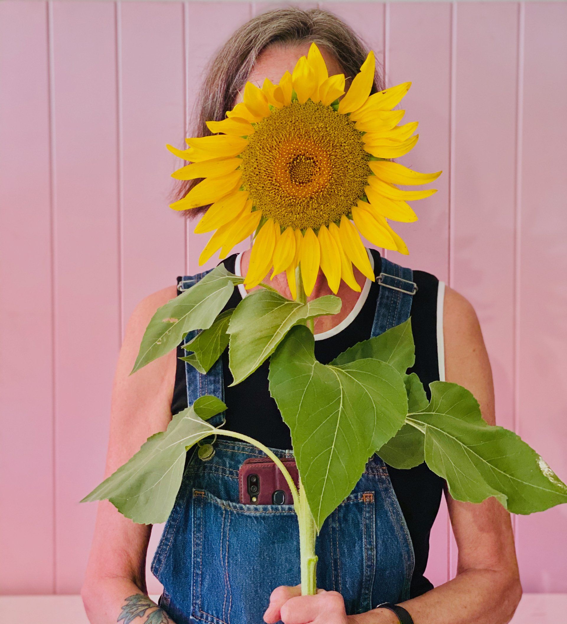 Florist designing a balanced and harmonious flower arrangement in a studio.