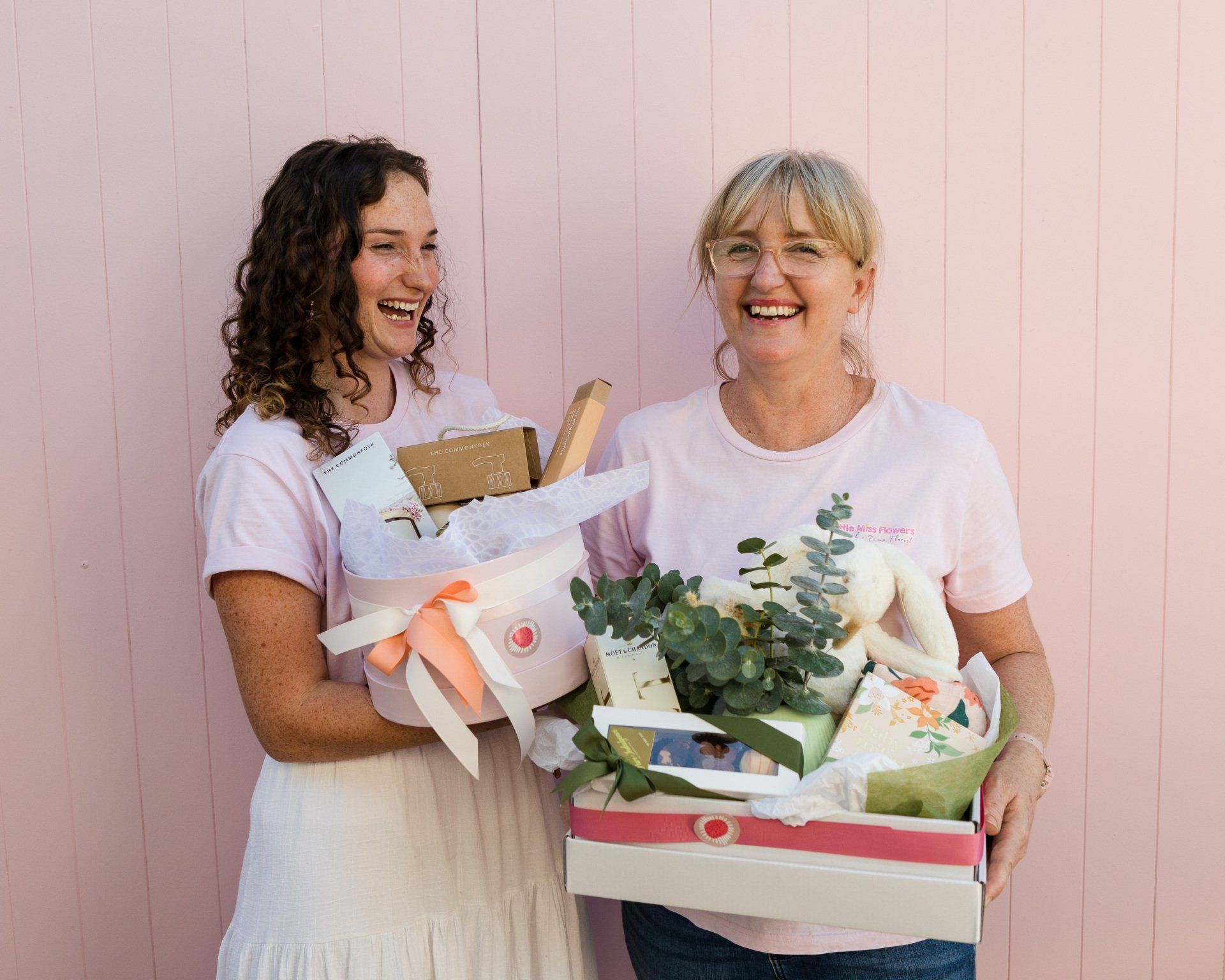 Darwin shop's team presenting baby gift boxes with care and affection.