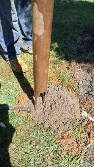 A person is digging a hole in the ground with a shovel.