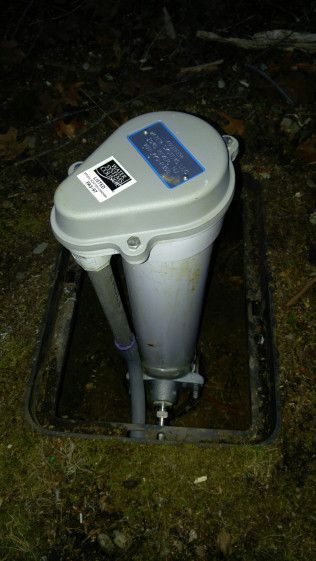 A white pipe is sitting in a hole in the ground.