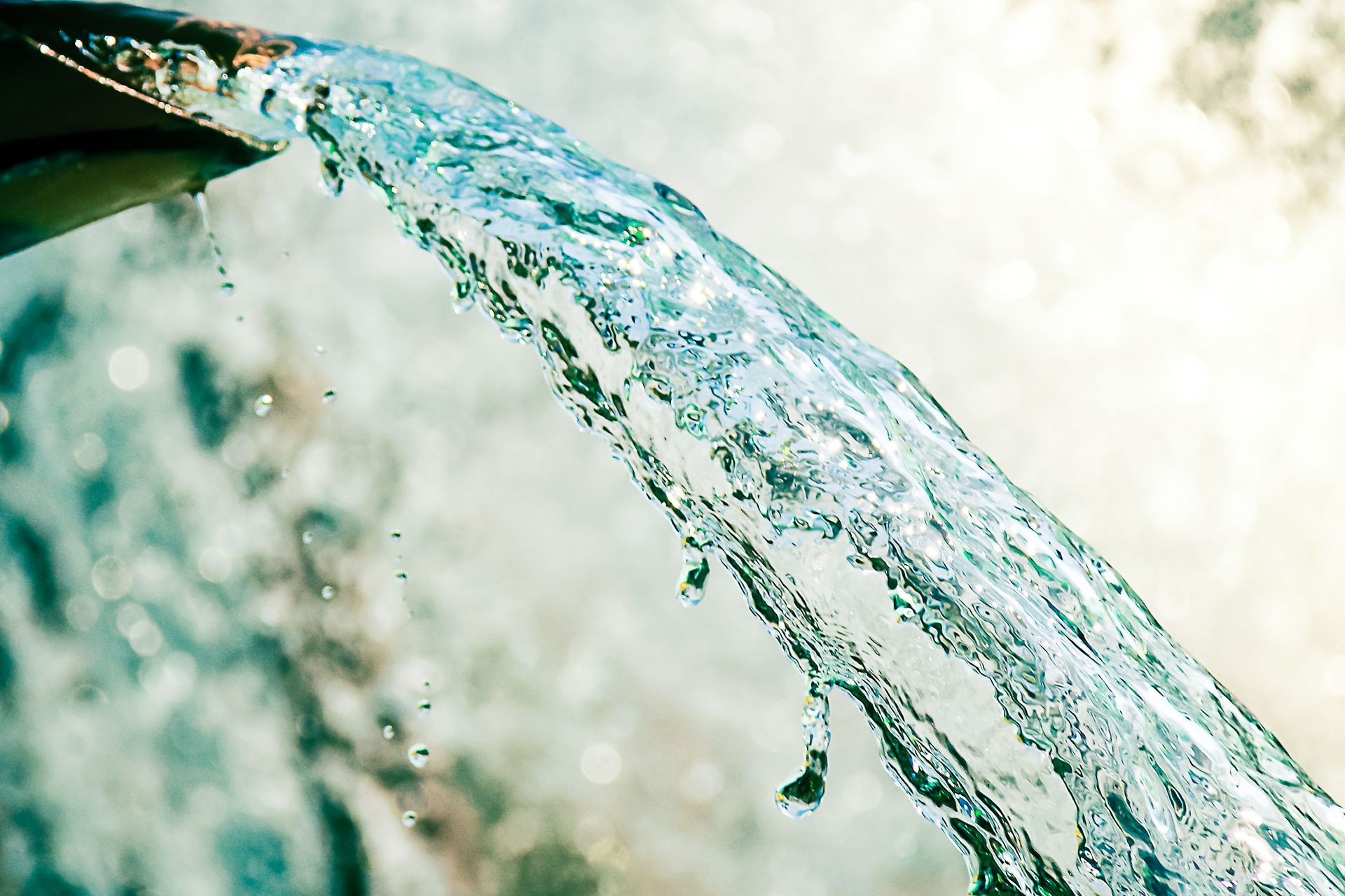 A close up of water coming out of a pipe.