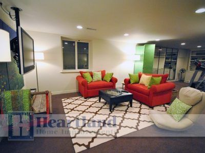 A living room with red chairs and a sign that says heartland