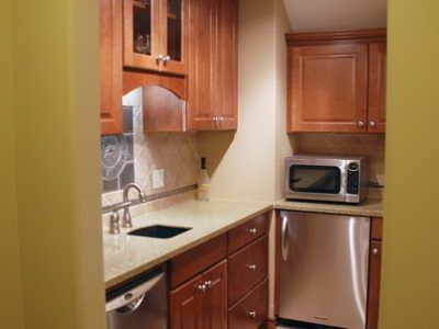 A kitchen with stainless steel appliances and wooden cabinets