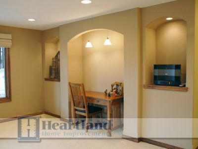 A room with a desk and chair and the word heartland on the bottom