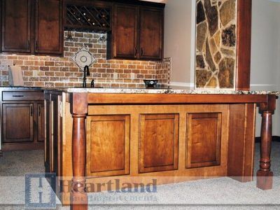 A kitchen with wooden cabinets and a heartland logo