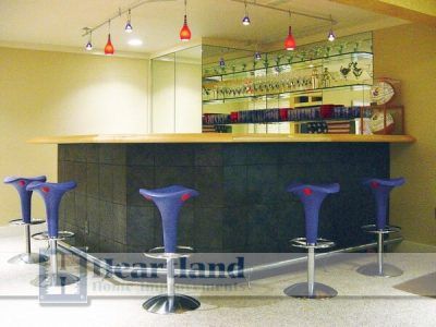 A bar with blue stools and a sign that says nearland