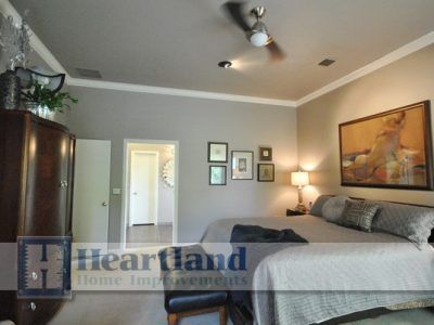 A bedroom with two beds and a sign that says hearland home improvements