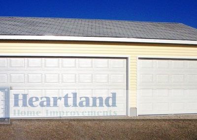 A garage with a heartland home improvements logo on it
