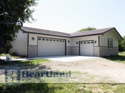 A house with two garage doors is for sale by heartland