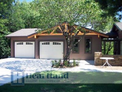 A house with a tree in front of it and a sign that says heartland