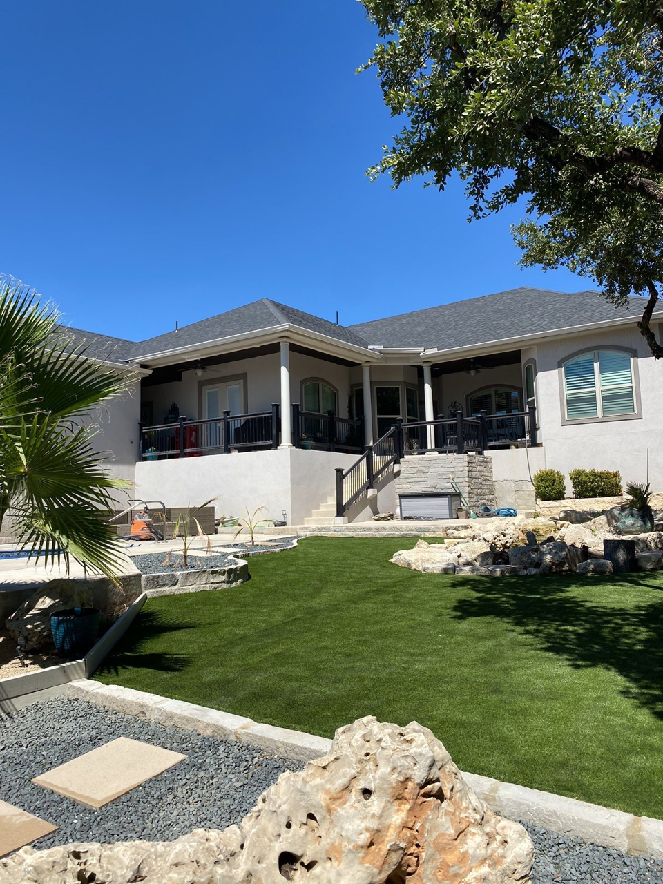 A large white house with a large lawn in front of it.