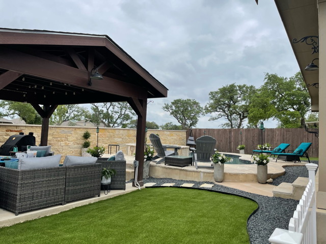 There is a gazebo in the middle of the backyard.