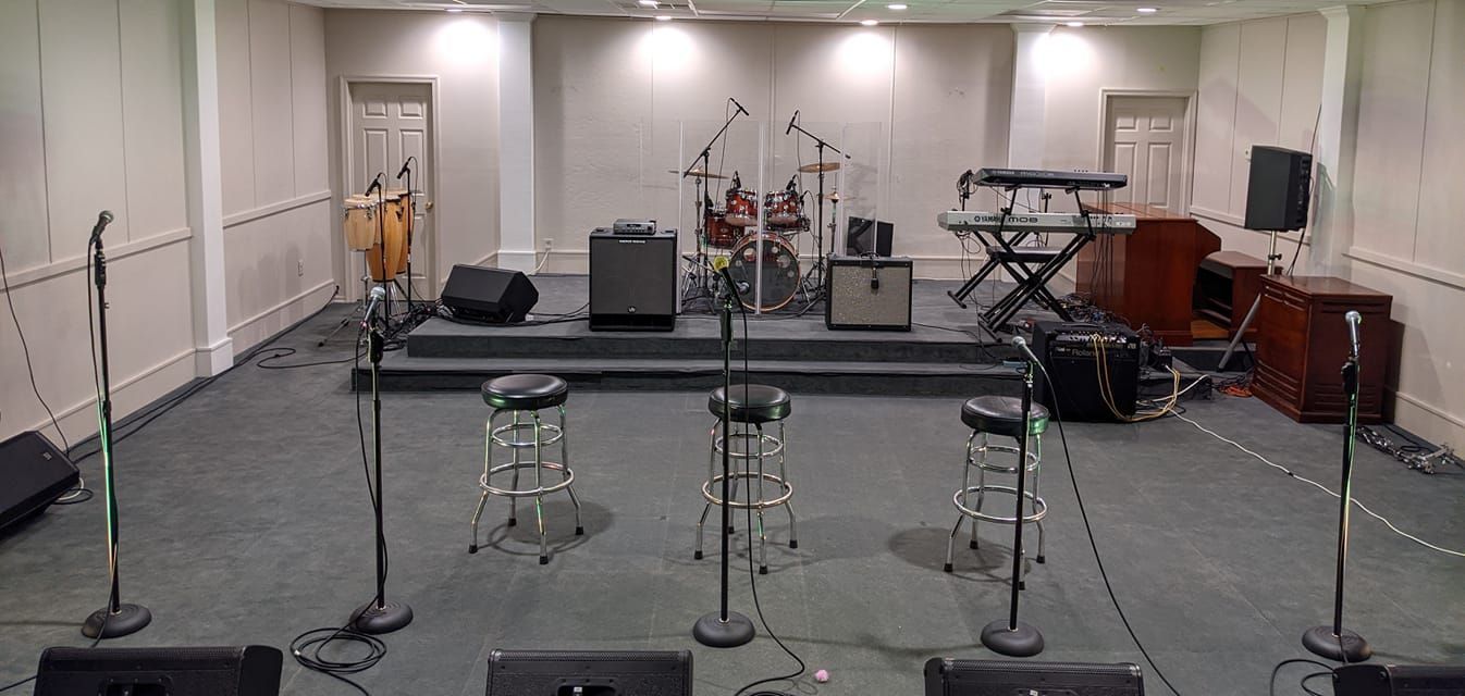 A recording studio stage with musical instruments and microphones set up.
