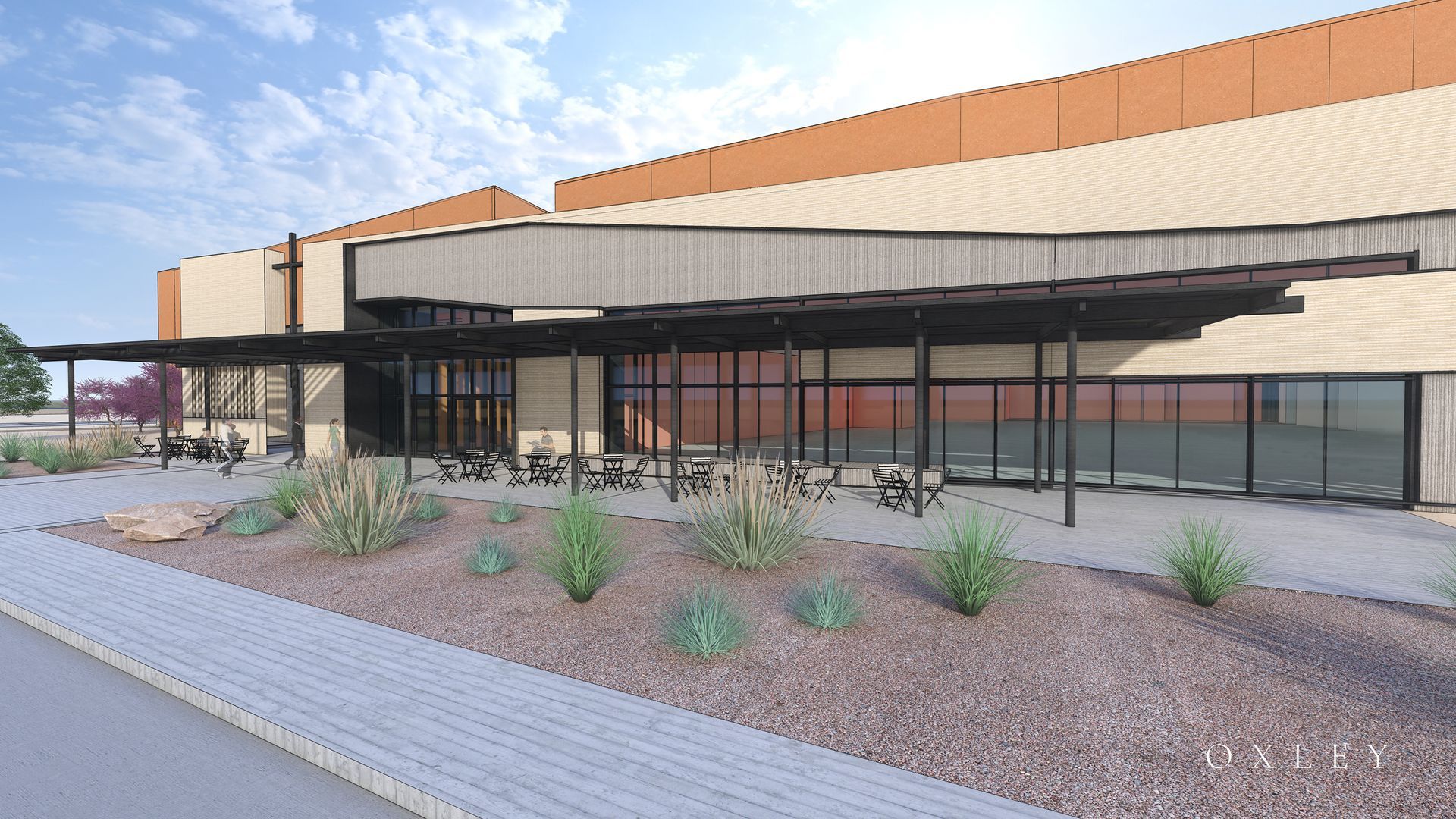 Building exterior with covered patio, glass windows, and desert landscaping.
