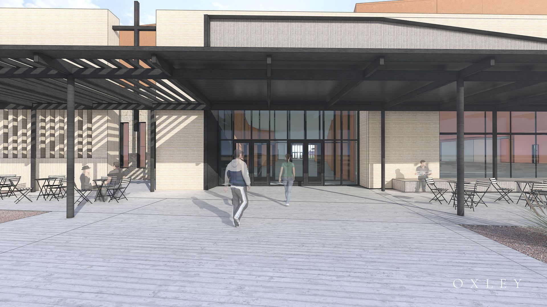 Exterior view of a modern building with a covered entrance; people walking and sitting at outdoor tables.