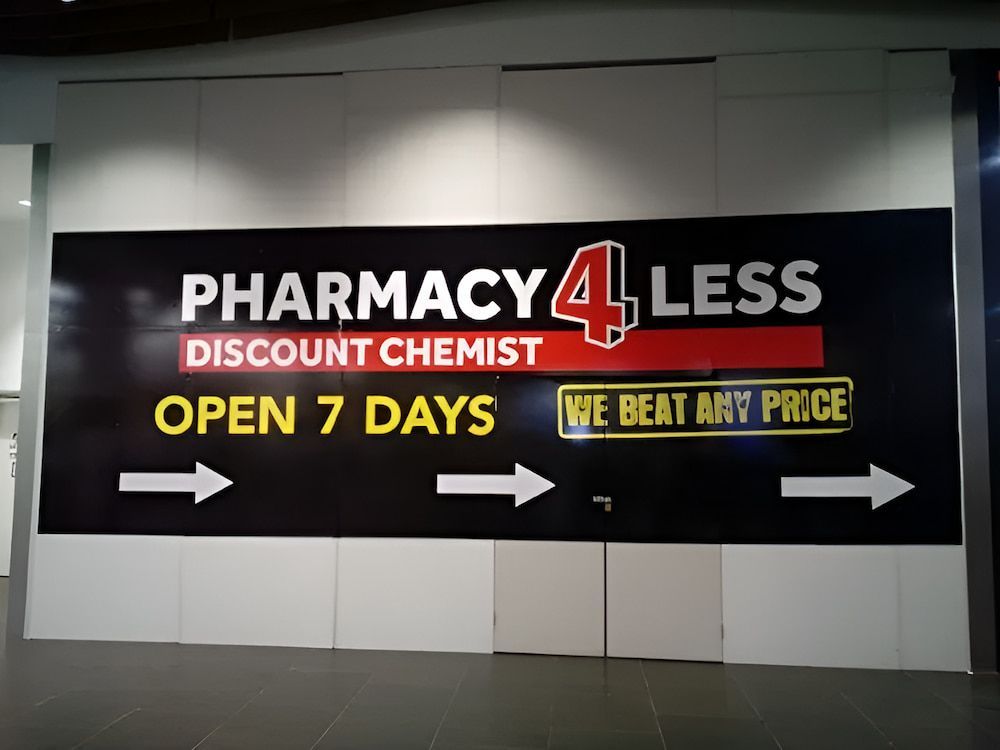 A Sign That Says Pharmacy 4 Less Discount Chemist Open 7 Days — Northern Territory Sign Services in Winnellie, NT