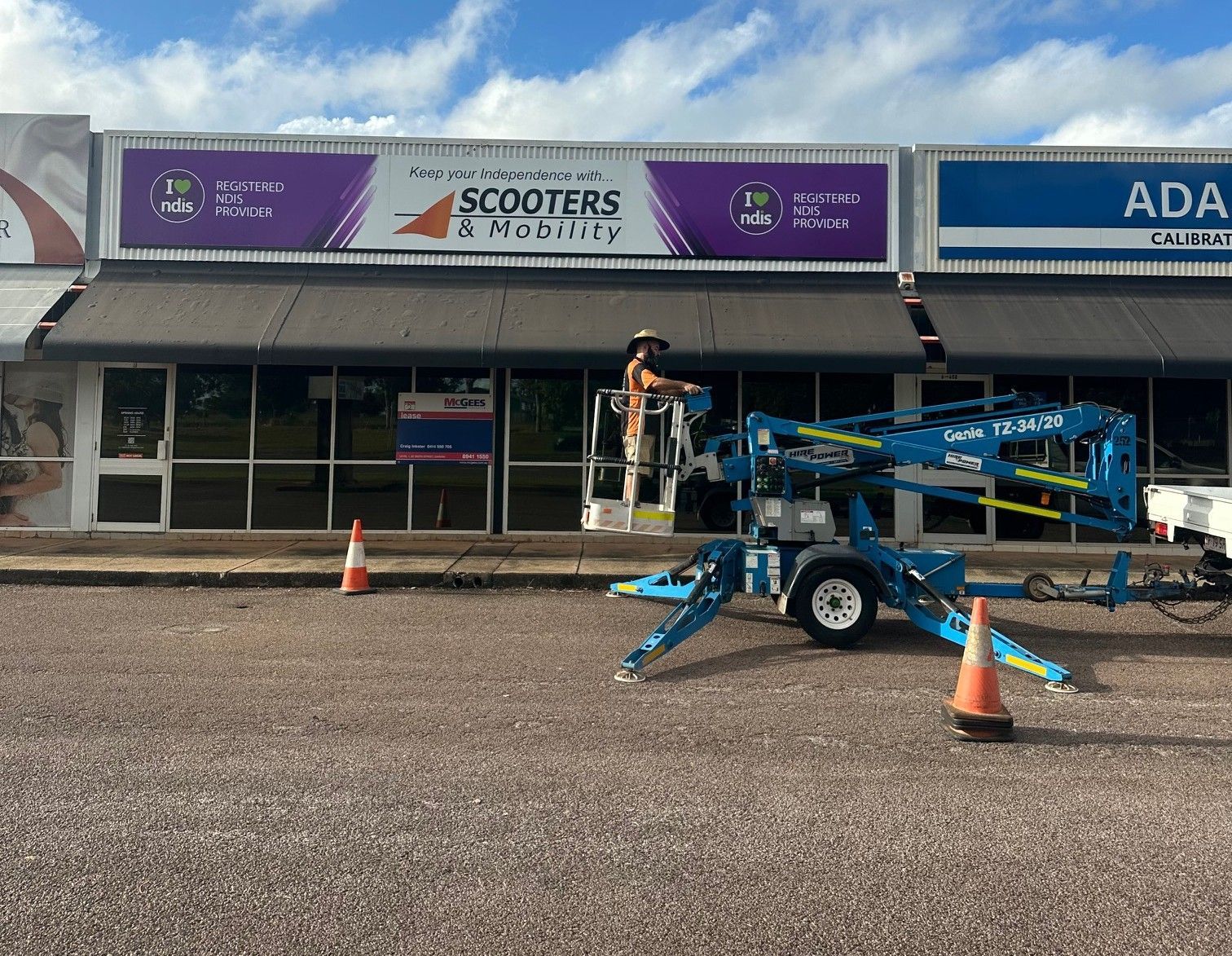 A Billboard For Hire Power Is On The Side Of A Dirt Road — Northern Territory Sign Services in Winnellie, NT