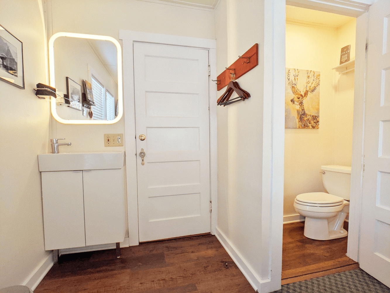 A bathroom with a sink , toilet and mirror.