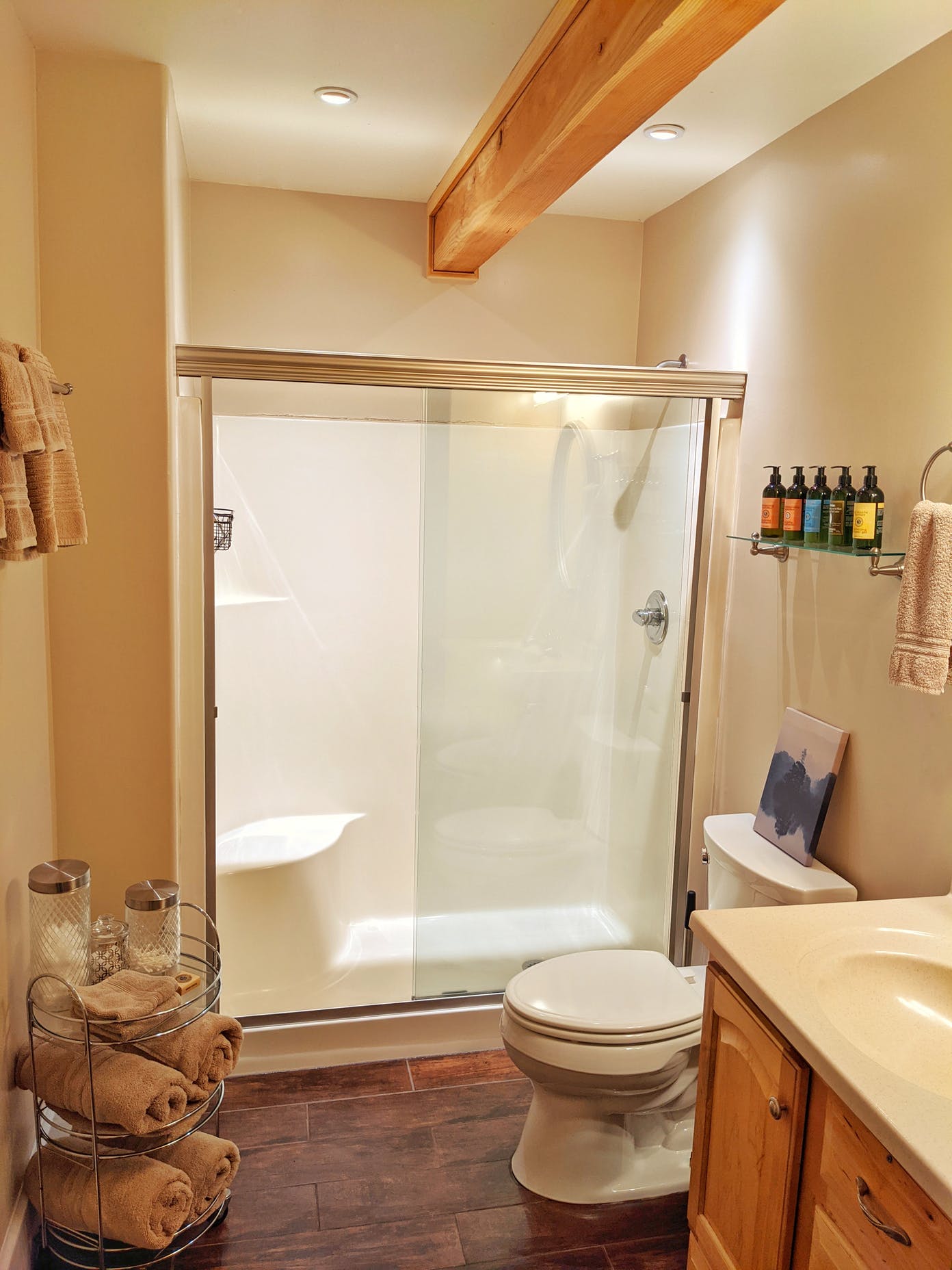 A bathroom with a toilet a sink and a shower