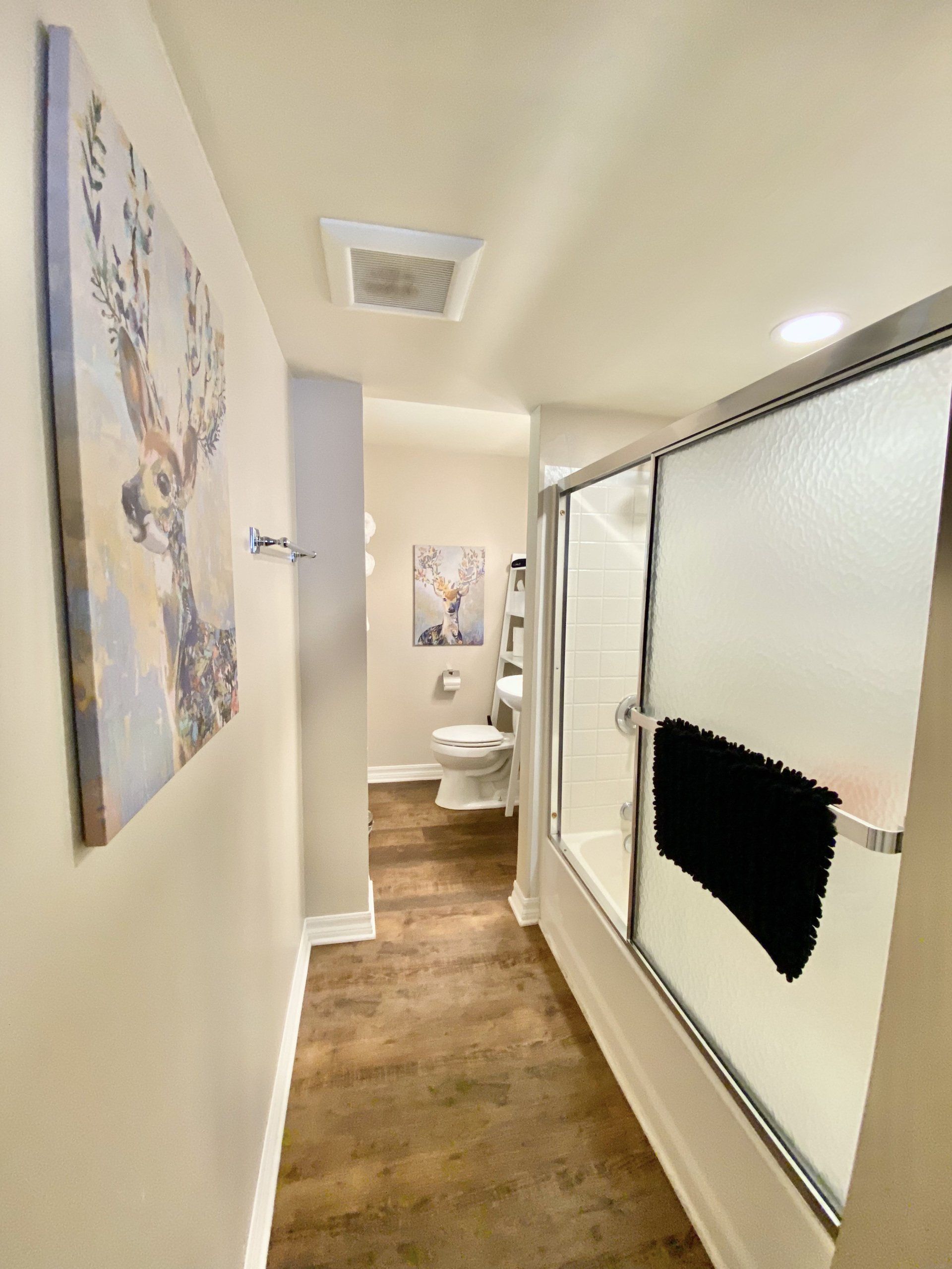 A bathroom with a walk in shower and a toilet.