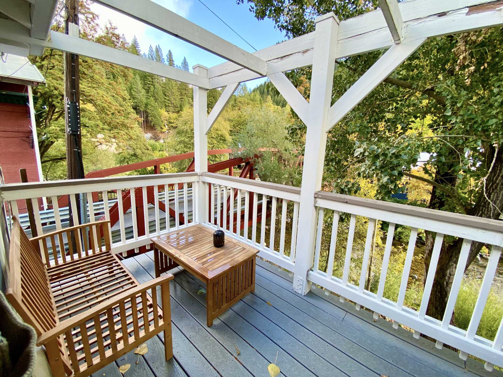 A wooden deck with a table and chairs on it.