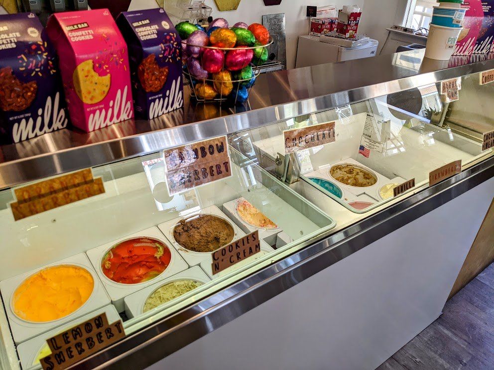 A display case filled with different types of cookies and ice cream.